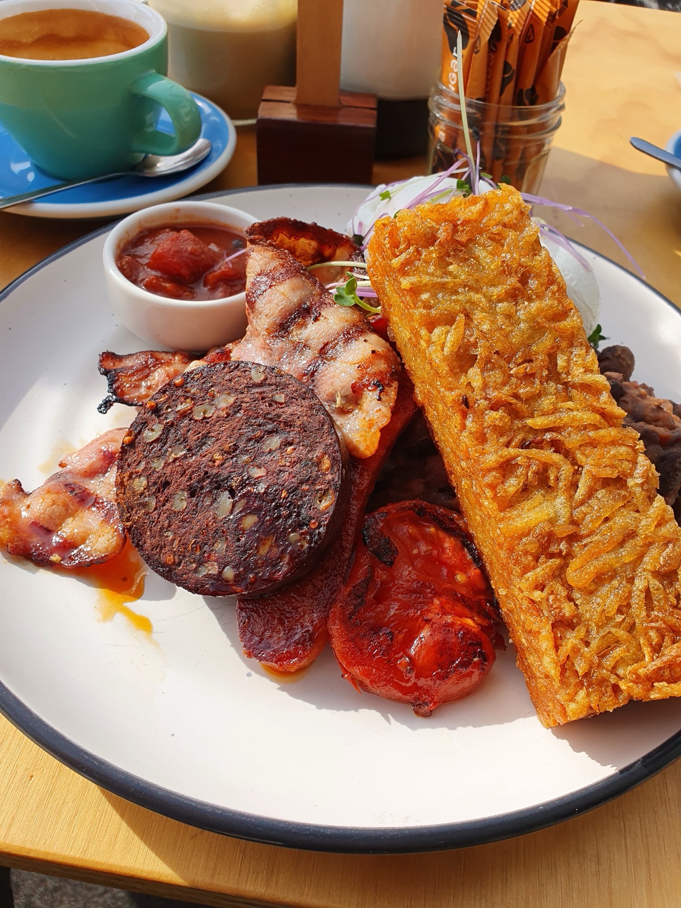Bacon, chorizo, hash brown and grilled tomato plate