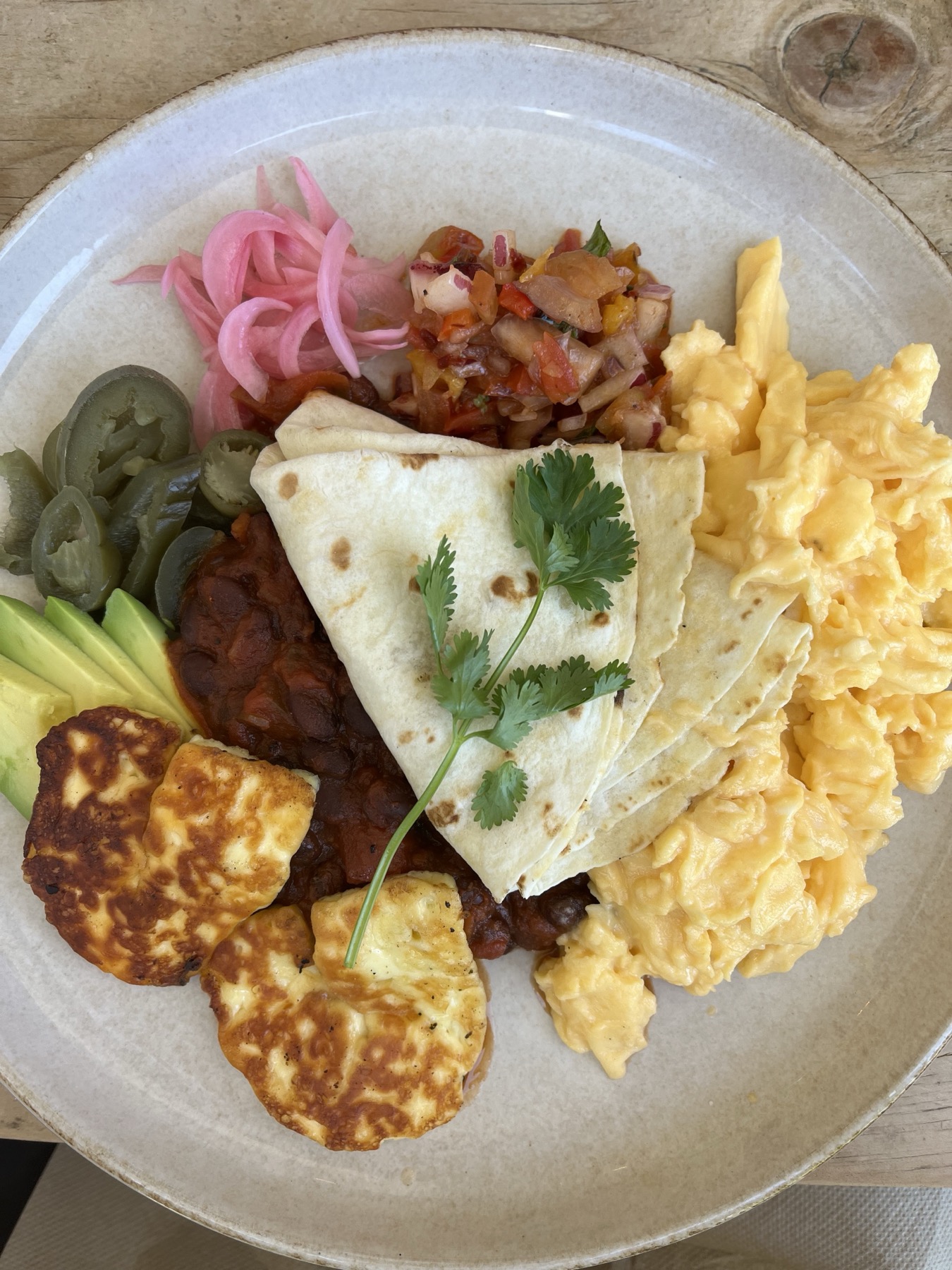 Scrambled eggs, quesadilla, salsa and pickled onion plate