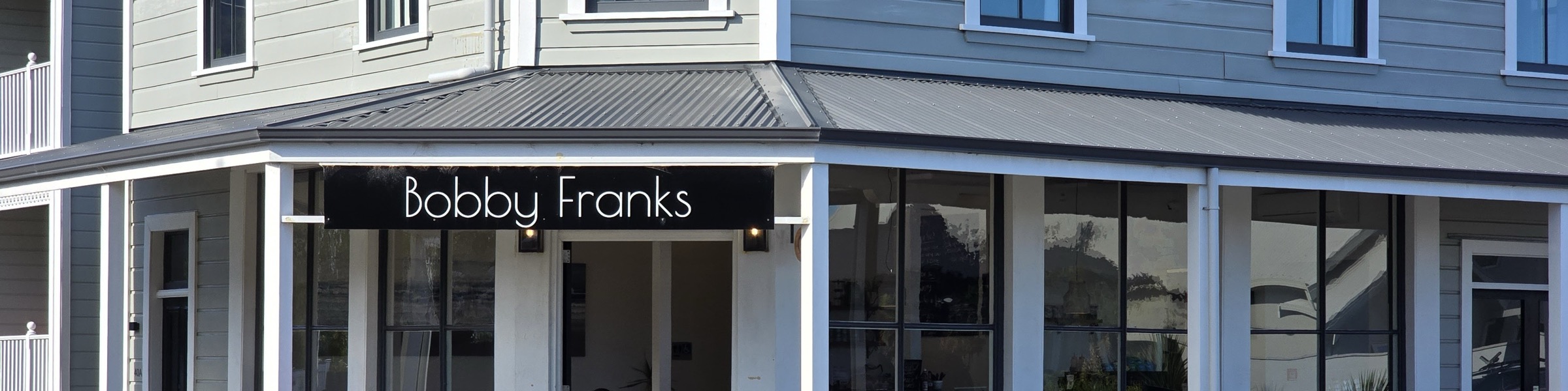 The Bobby Franks sign on the villa's black awning